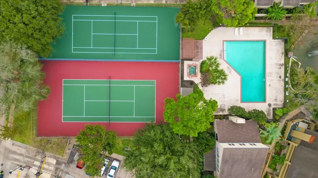 a view of a house with a yard and potted plants