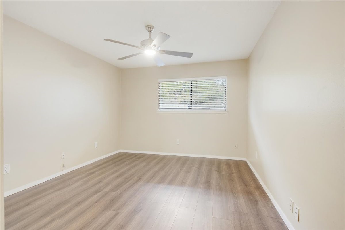 3502 Ocee Street, Unit 3502 Houston, TX 77063 - Photo 7 of 25 wooden floor in an empty room with a window