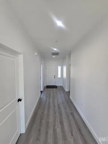 a view of a room with wooden floor and window
