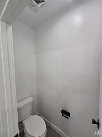 a white toilet sitting next to a shower
