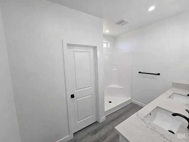 a bathroom with a sink and shower