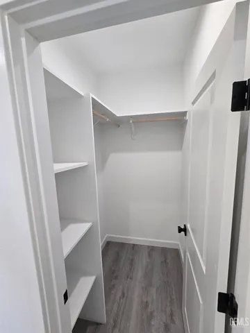 a view of walk in closet with empty racks