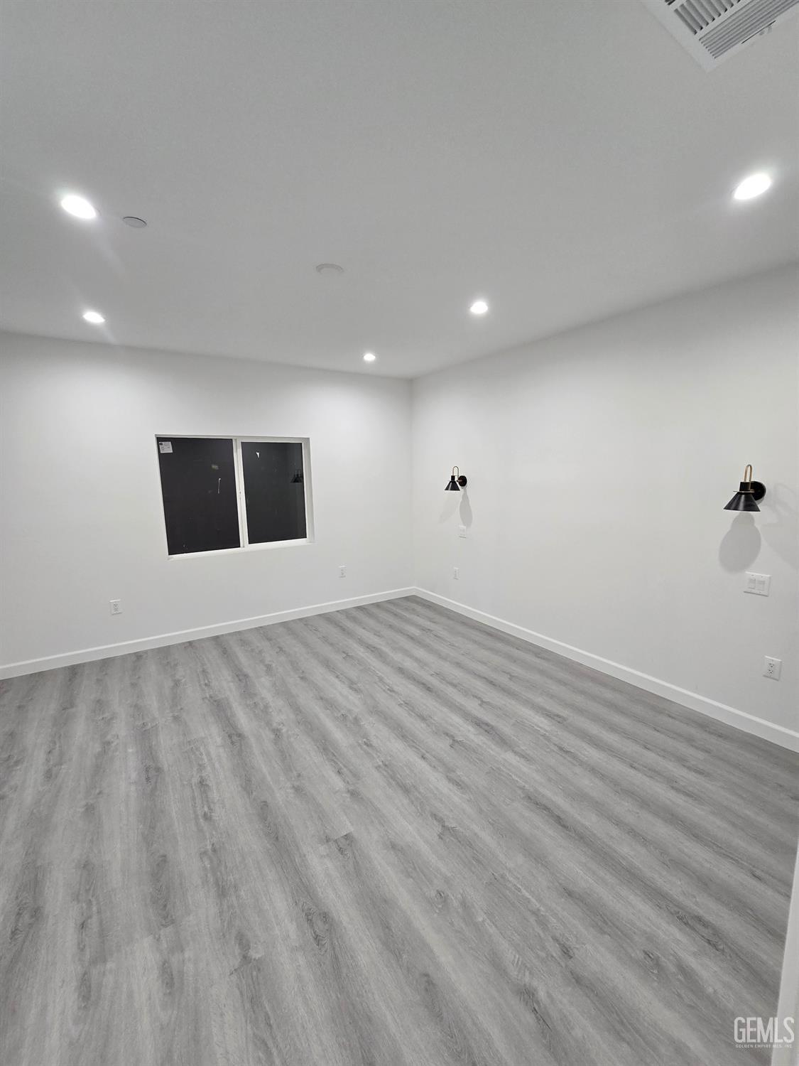 Undisclosed Address California City, CA 93505 - Photo 35 of 41 an empty room with wooden floor and windows