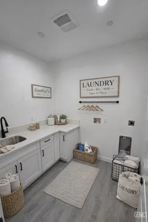 a large kitchen with a table and chairs