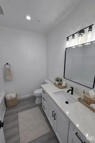 a kitchen with stainless steel appliances a stove a sink and a refrigerator