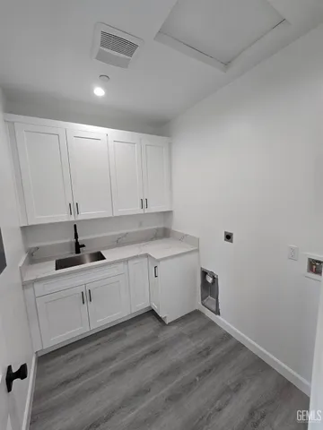 a kitchen with sink cabinets and wooden floor