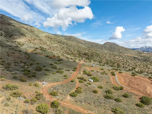 a view of a dry yard with mountains
