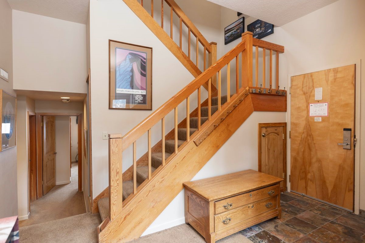 240 Tennis Club Road, Unit 1664 Keystone, CO 80435 - Photo 9 of 26 Stairway with carpet floors and a towering ceiling