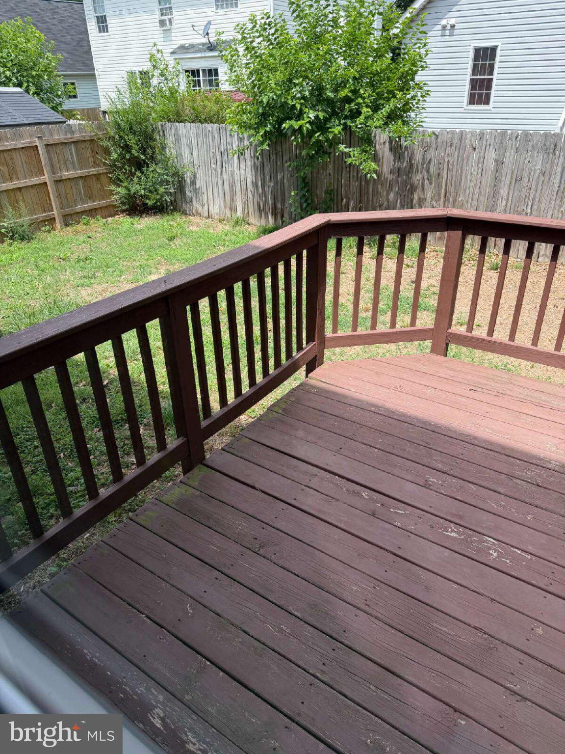 313 3rd Street Colonial Beach, VA 22443 - Photo 28 of 36 Sunny deck overlooking a lush yard.