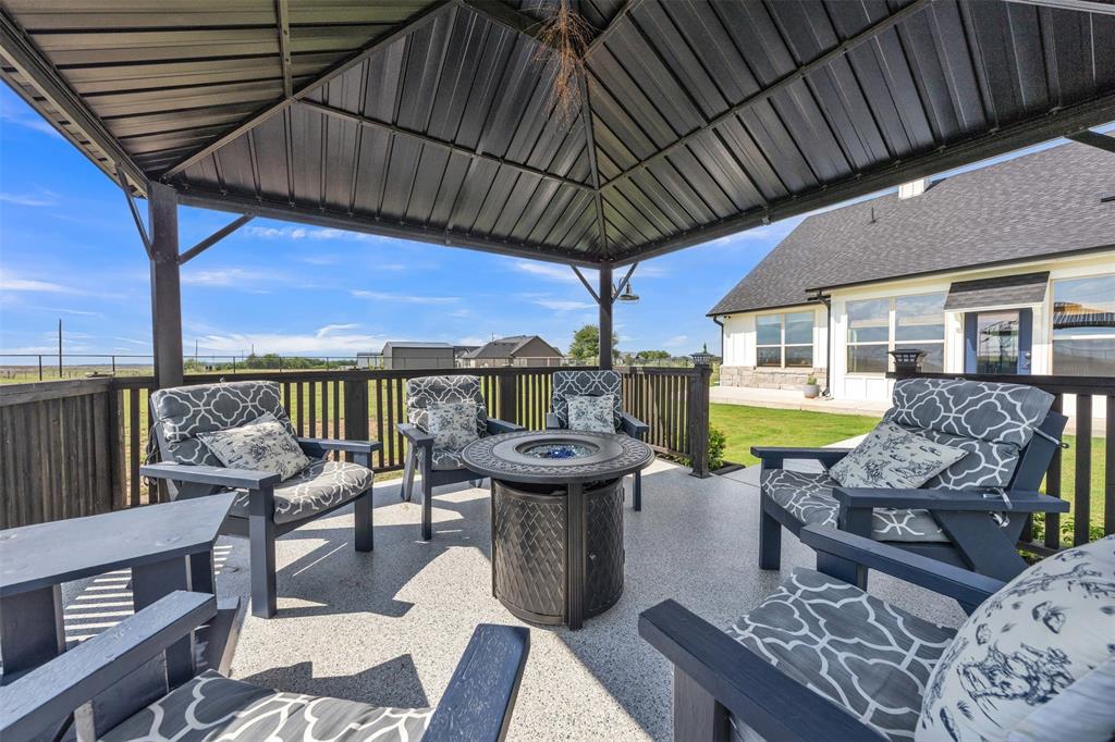 6628 Buffalo Ridge Circle Godley, TX 76044 - Photo 30 of 39 a view of a patio with couches chairs and a table and chairs with wooden floor