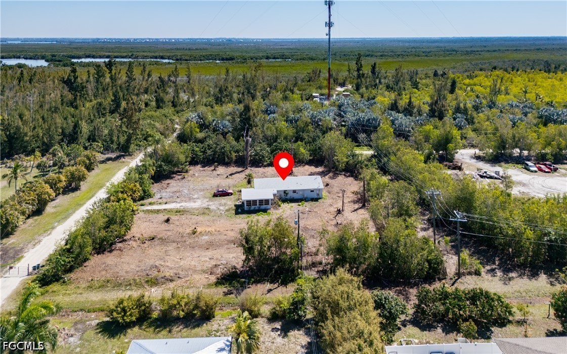 5427 Easy Street Bokeelia, FL 33922 - Photo 4 of 9 a aerial view of a house with a yard and lake view