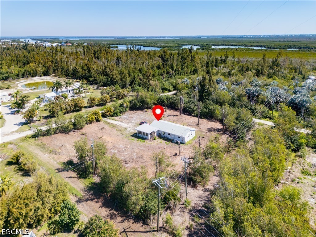 5427 Easy Street Bokeelia, FL 33922 - Photo 6 of 9 a backyard of a house with a yard and lake view