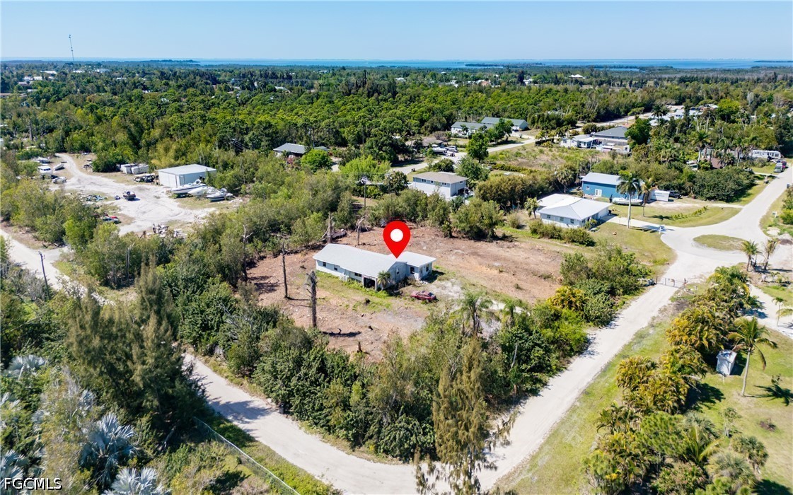 5427 Easy Street Bokeelia, FL 33922 - Photo 9 of 9 a aerial view of a house with a yard and lake view