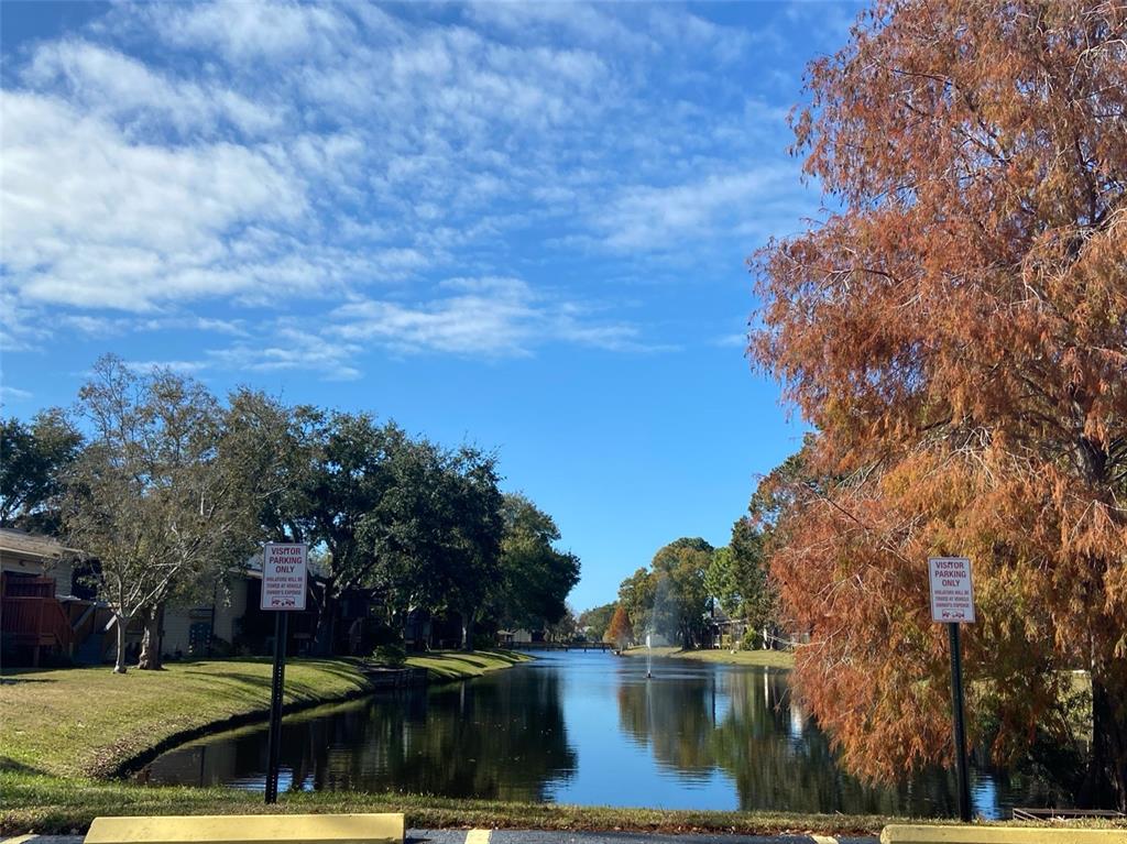 a view of lake with a house in background
