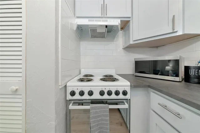 a kitchen with a refrigerator and cabinets