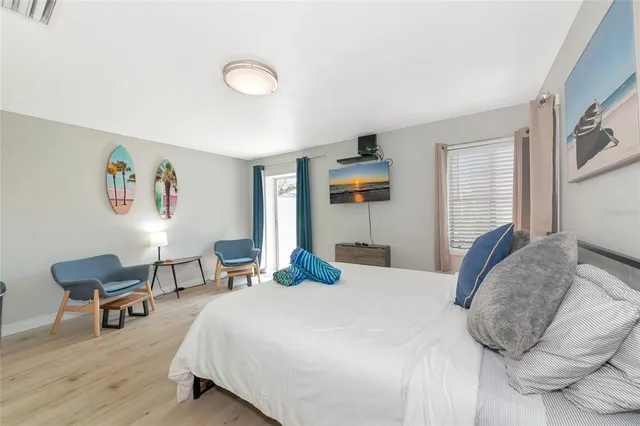 a bedroom with a large bed and a window