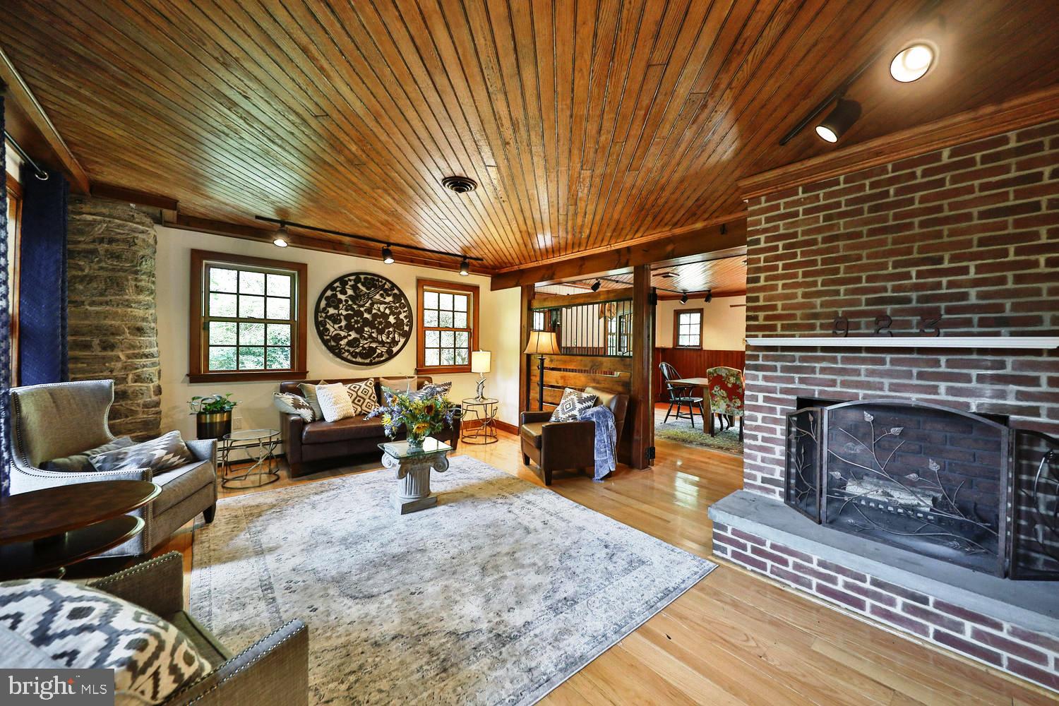 923 Rydal Road Jenkintown, PA 19046 - Photo 2 of 56 a living room with furniture a fireplace and a table