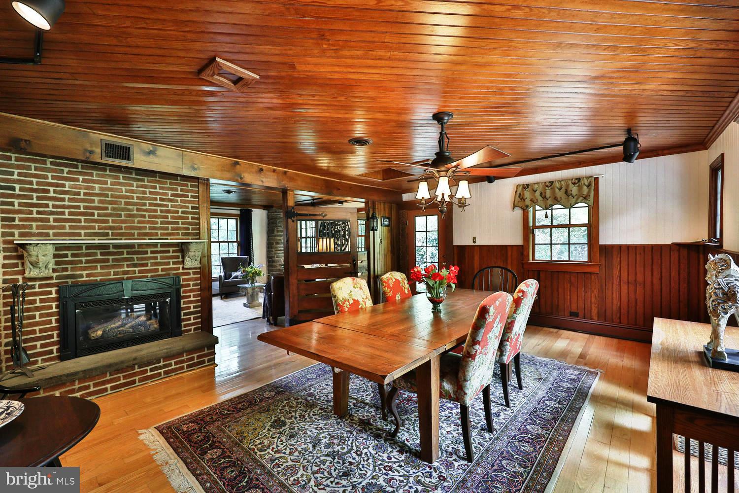 923 Rydal Road Jenkintown, PA 19046 - Photo 11 of 56 a dining room with furniture a fireplace and wooden floor