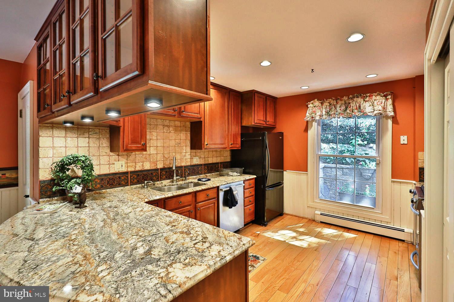923 Rydal Road Jenkintown, PA 19046 - Photo 15 of 56 a kitchen with stainless steel appliances kitchen island granite countertop a stove a refrigerator and a view of living room