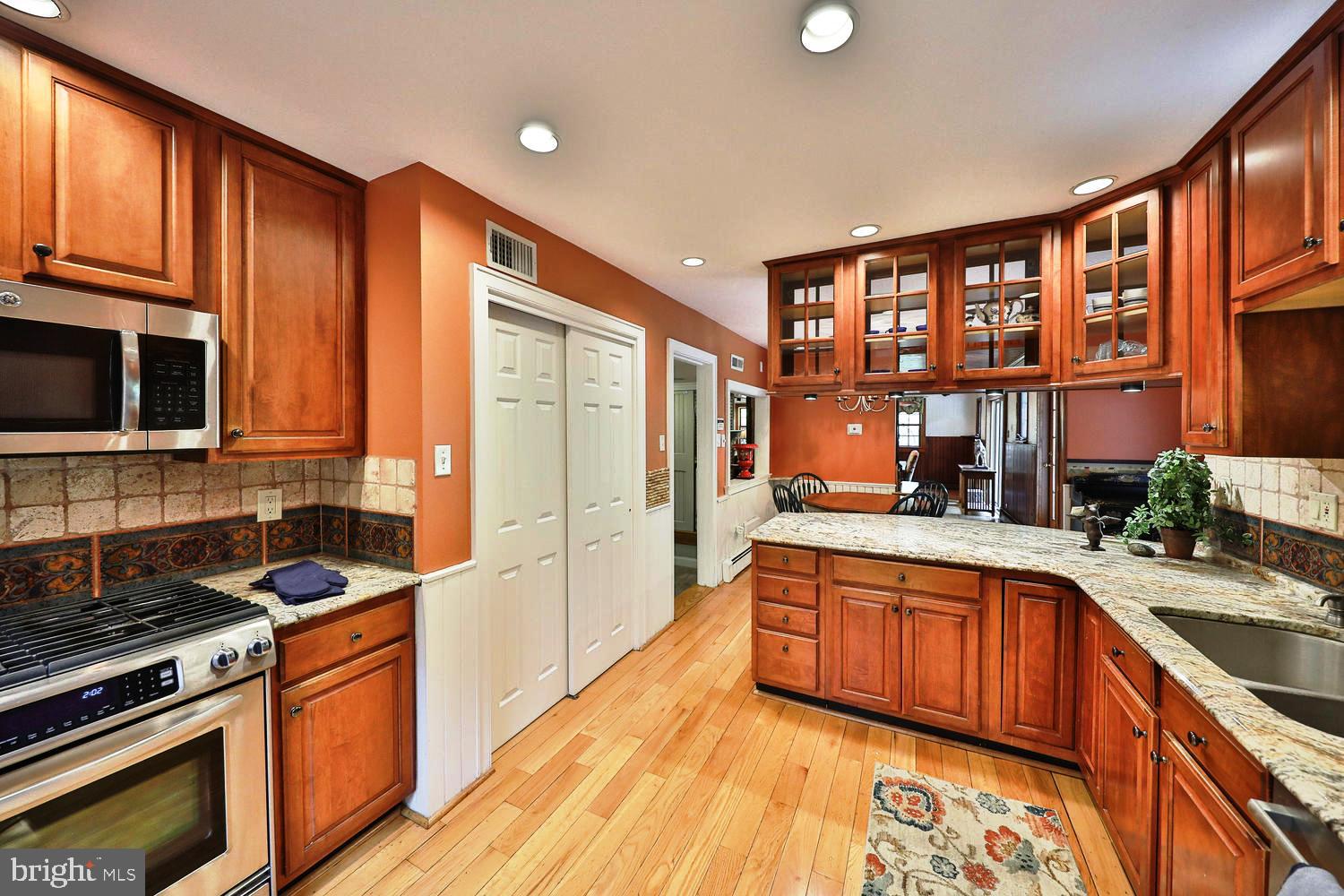 923 Rydal Road Jenkintown, PA 19046 - Photo 17 of 56 a kitchen with stainless steel appliances granite countertop a stove sink and cabinets