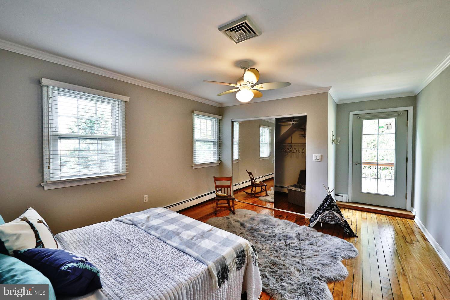 923 Rydal Road Jenkintown, PA 19046 - Photo 22 of 56 a bedroom with a bed and a large window with chair