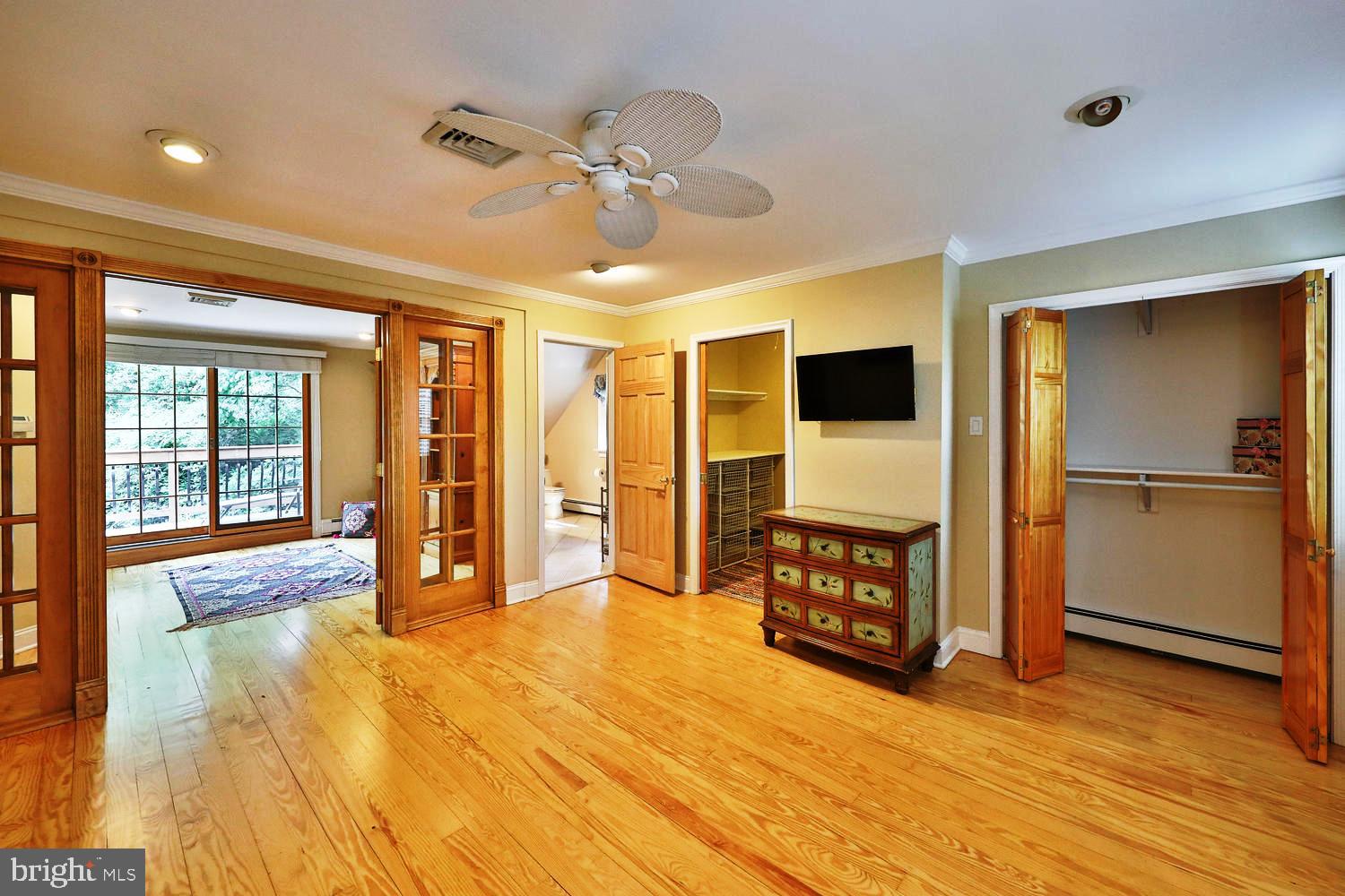 923 Rydal Road Jenkintown, PA 19046 - Photo 28 of 56 a spacious bedroom with a bed and wooden floor