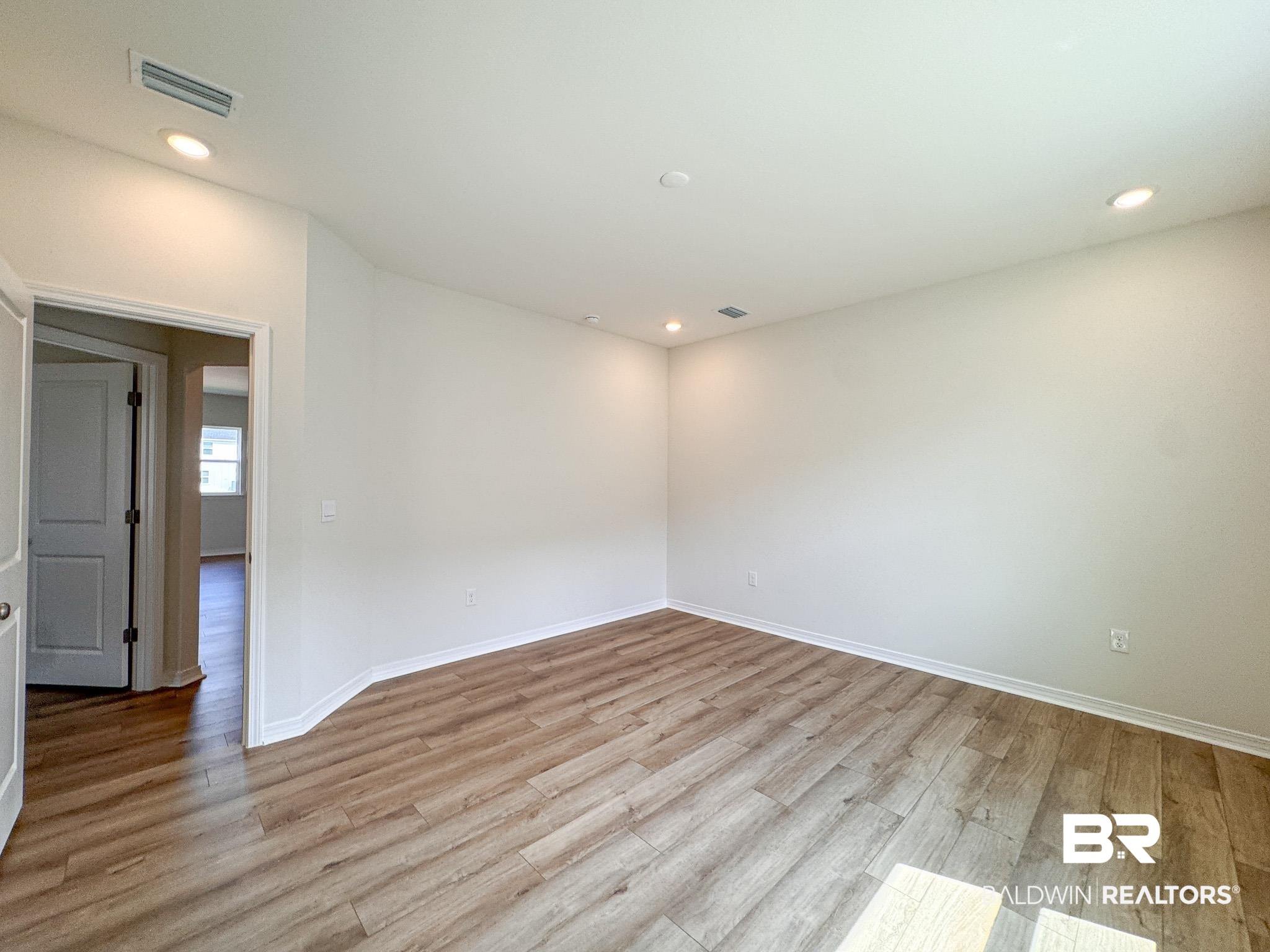 18151 Kent Circle Foley, AL 36535 - Photo 21 of 25 Spacious room featuring wood-finish flooring and recessed ceiling lighting