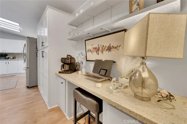 a kitchen with a sink cabinets and wooden floor