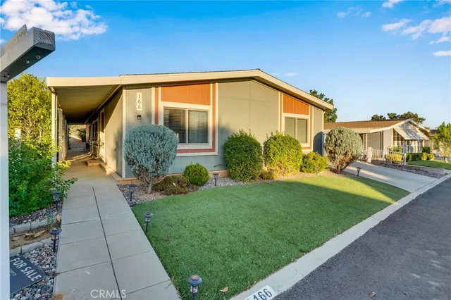 a view of an house with backyard space and garden