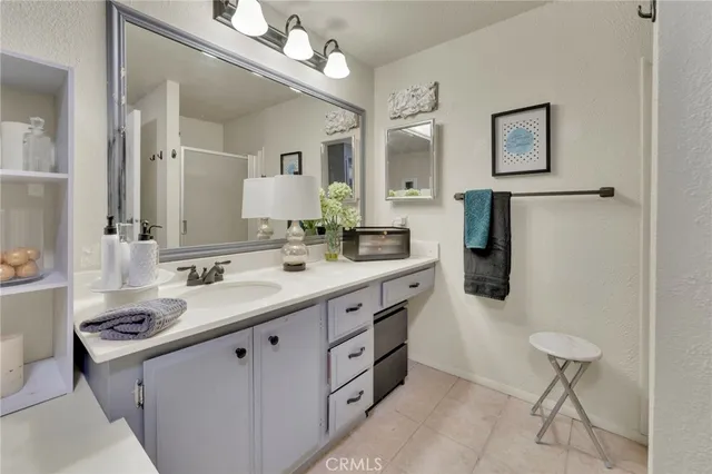 a spacious bathroom with a double vanity sink a mirror and a bathtub