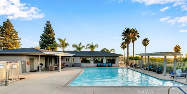 a view of a house with floor to ceiling windows and a table