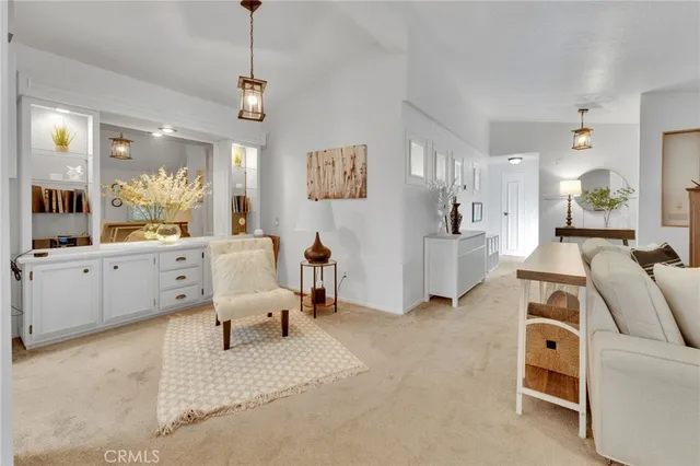 a living room with furniture and a chandelier