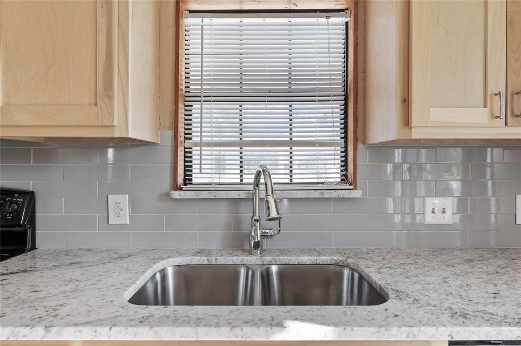 208 West Maple Street Gunter, TX 75058 - Photo 12 of 32 a kitchen with a sink a window and cabinets