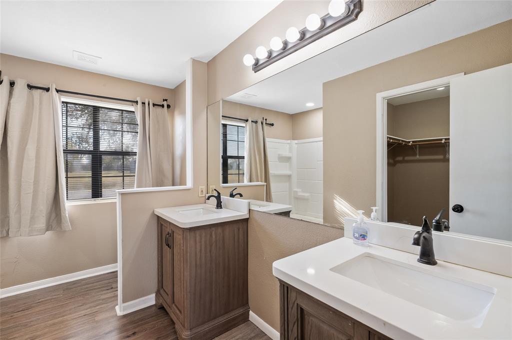 208 West Maple Street Gunter, TX 75058 - Photo 15 of 32 a bathroom with a sink double vanity and a mirror