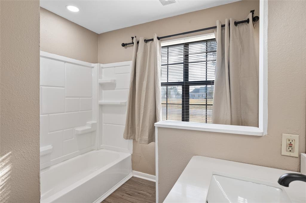 208 West Maple Street Gunter, TX 75058 - Photo 16 of 32 a bathroom with a tub shower and a sink