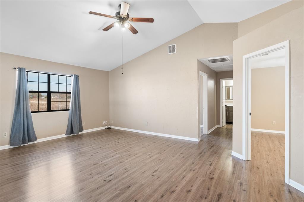 208 West Maple Street Gunter, TX 75058 - Photo 17 of 32 wooden floor in an empty room with a window