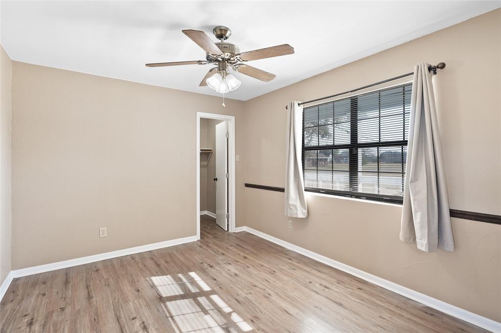 208 West Maple Street Gunter, TX 75058 - Photo 18 of 32 a view of an empty room with wooden floor and a window