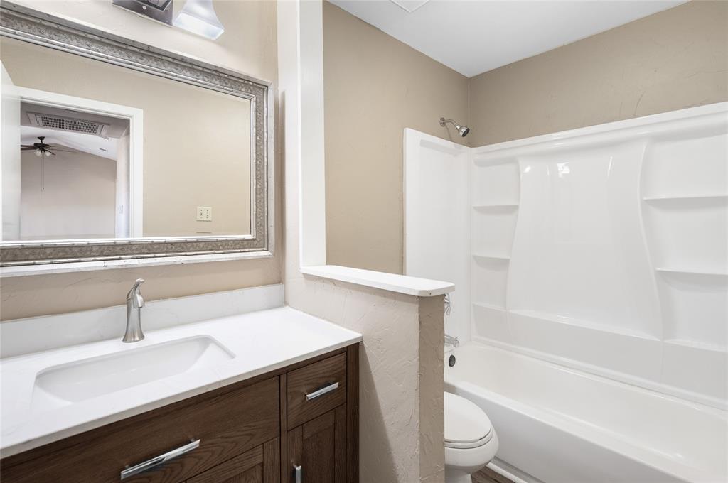 208 West Maple Street Gunter, TX 75058 - Photo 20 of 32 a bathroom with a sink a toilet and shower