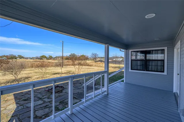 a view of roof deck with large ocean and wooden floor