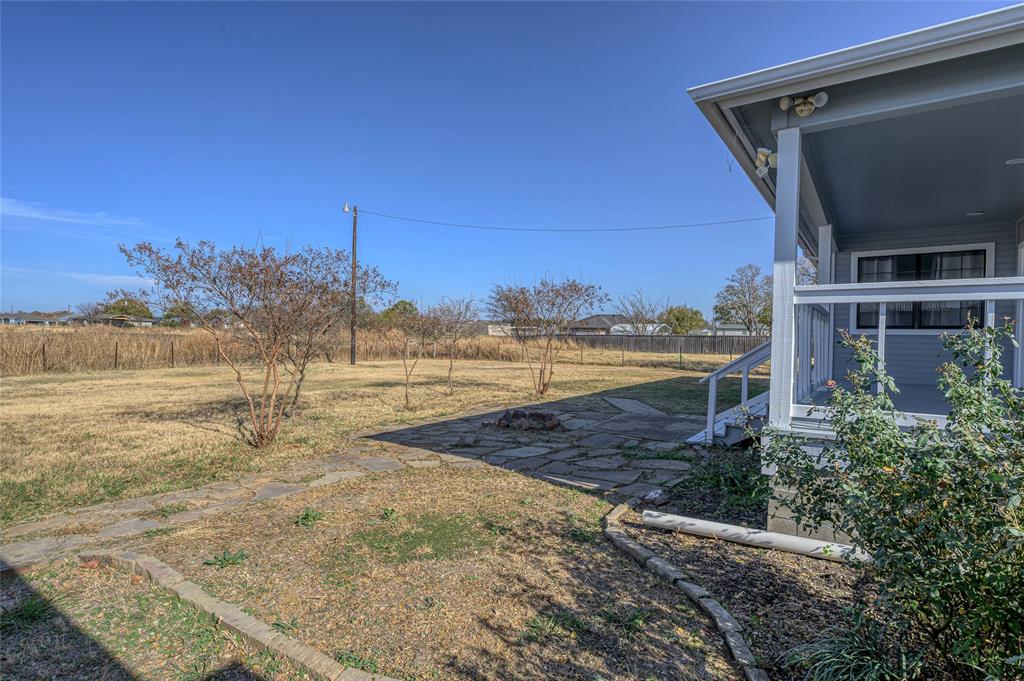 208 West Maple Street Gunter, TX 75058 - Photo 26 of 32 a view of a yard with an ocean view