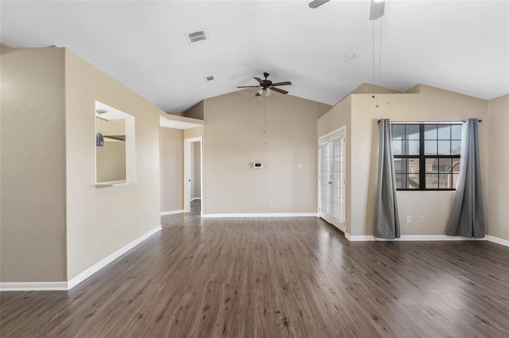 208 West Maple Street Gunter, TX 75058 - Photo 7 of 32 a view of an empty room with window and wooden floor