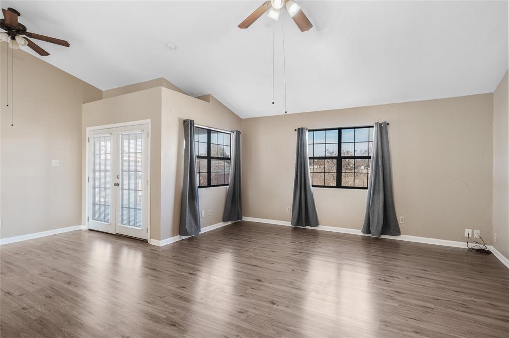 208 West Maple Street Gunter, TX 75058 - Photo 8 of 32 a view of an empty room with wooden floor and a window