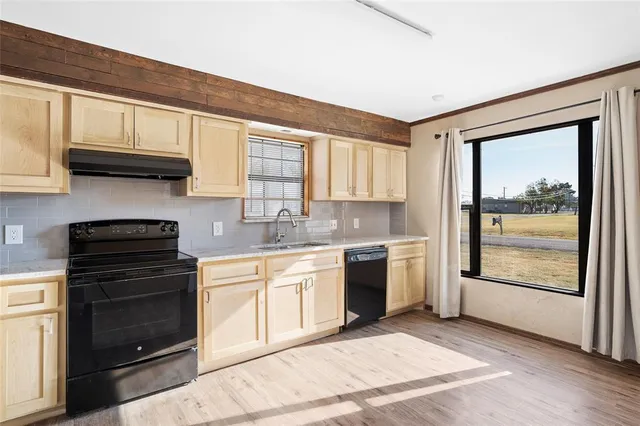 a kitchen with a stove a sink and a microwave