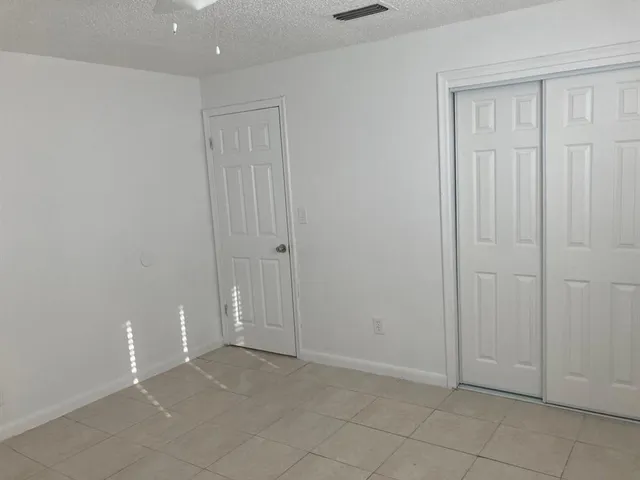 an empty room with closet area