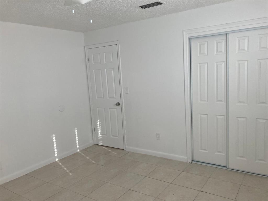 3600 Riverside Drive, Unit B Coral Springs, FL 33065 - Photo 4 of 9 an empty room with closet area