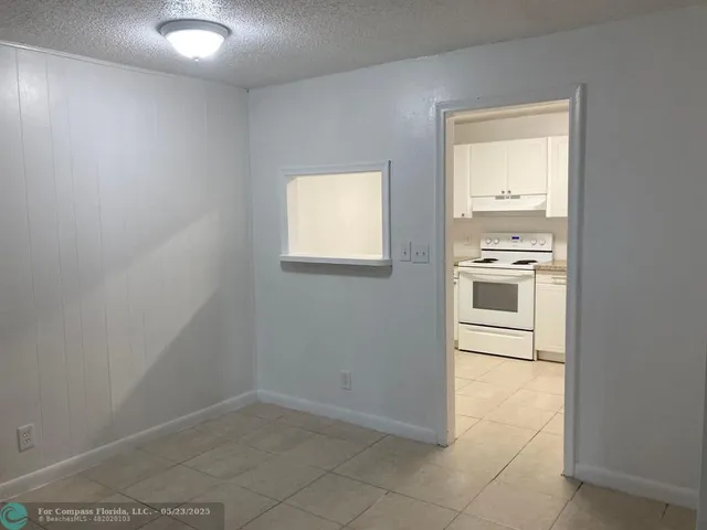 an empty room with kitchen appliances and cabinets