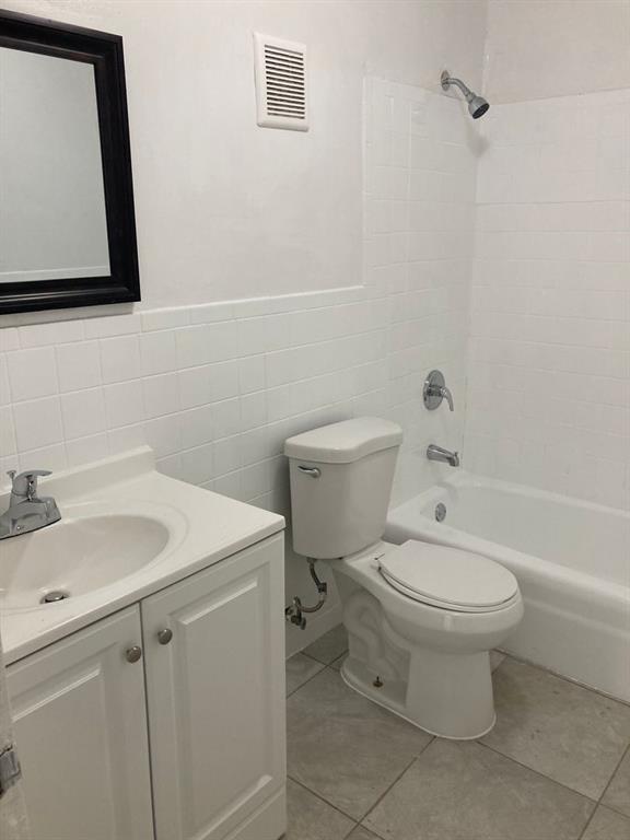3600 Riverside Drive, Unit B Coral Springs, FL 33065 - Photo 7 of 9 a white toilet sitting next to a bathroom sink