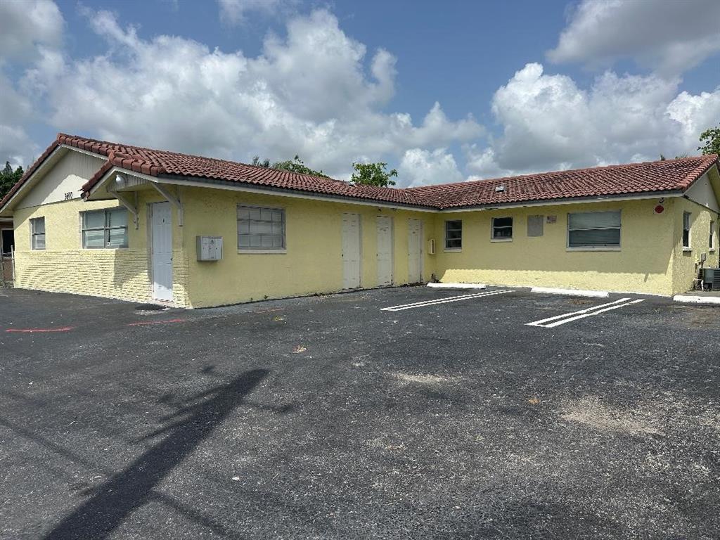 3600 Riverside Drive, Unit B Coral Springs, FL 33065 - Photo 9 of 9 a front view of a house with a garden