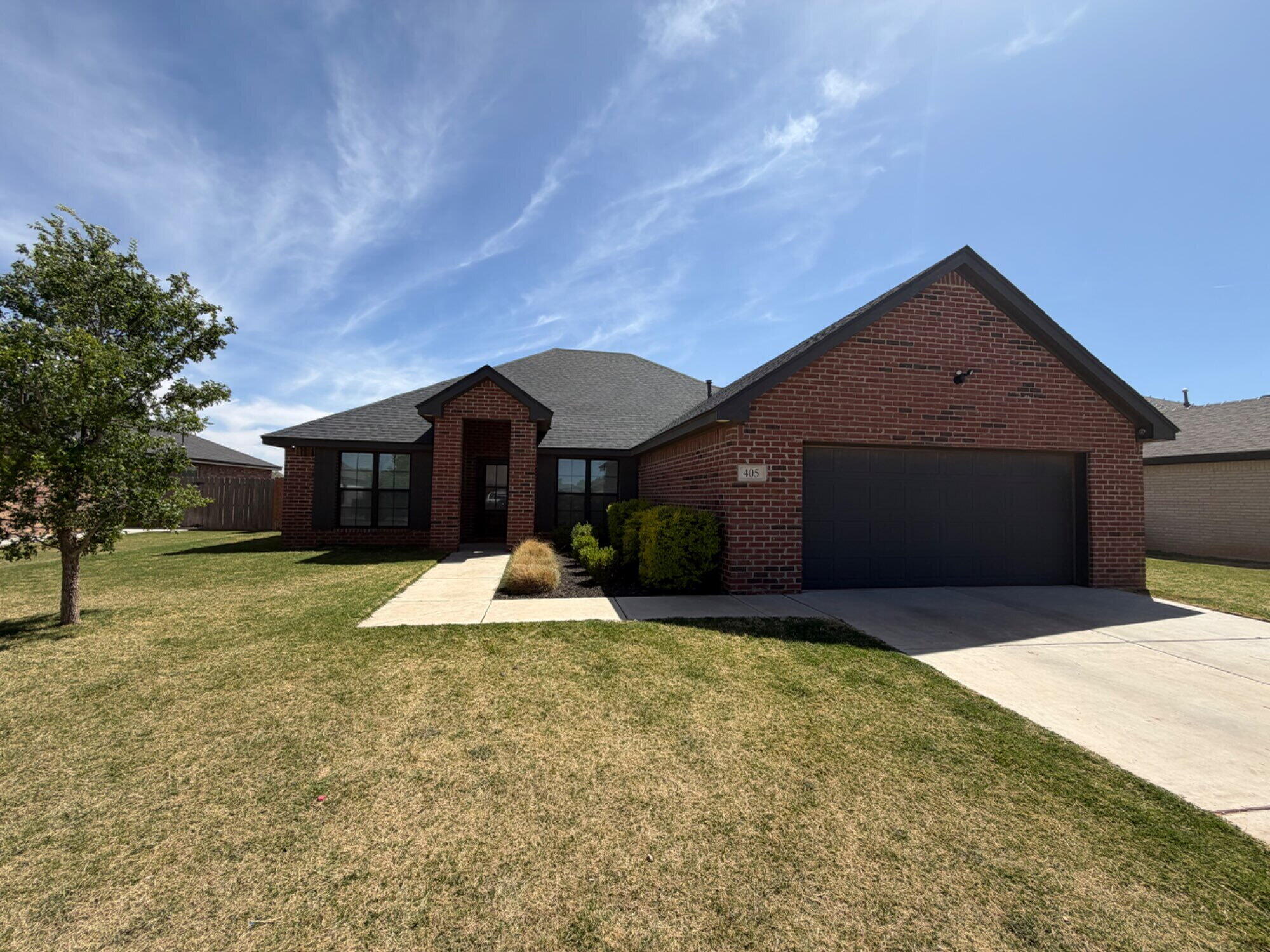 405 Ranger Street Wolfforth, TX 79382 - Photo 1 of 19 a front view of a house with a yard and garage