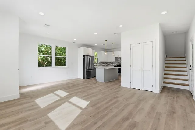 a view of a kitchen with a sink a refrigerator and window